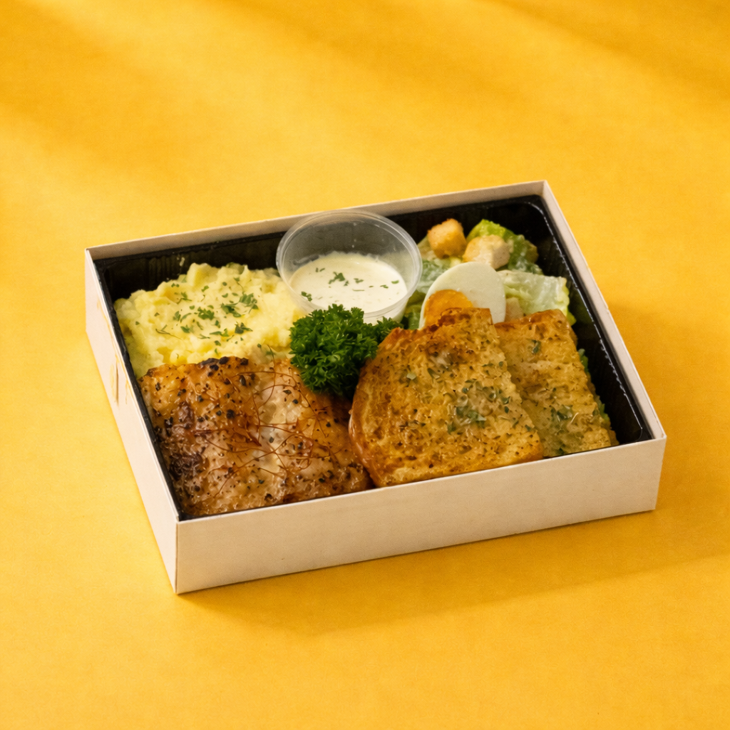Grilled fish bento with lemon butter béchamel, mash, yuzu Caesar and garlic bread