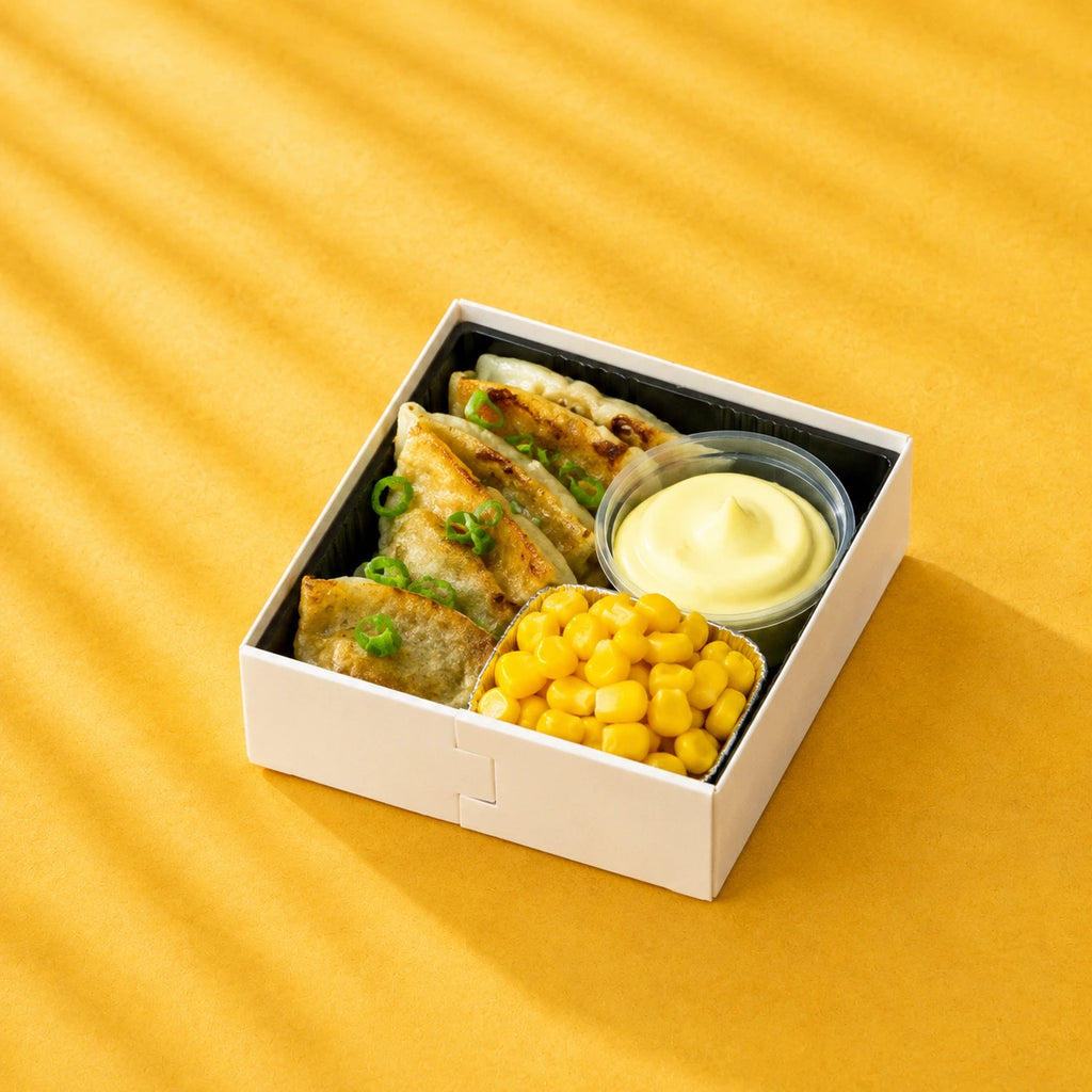 Crispy spring onion pancake with corn and dipping sauce on a yellow background