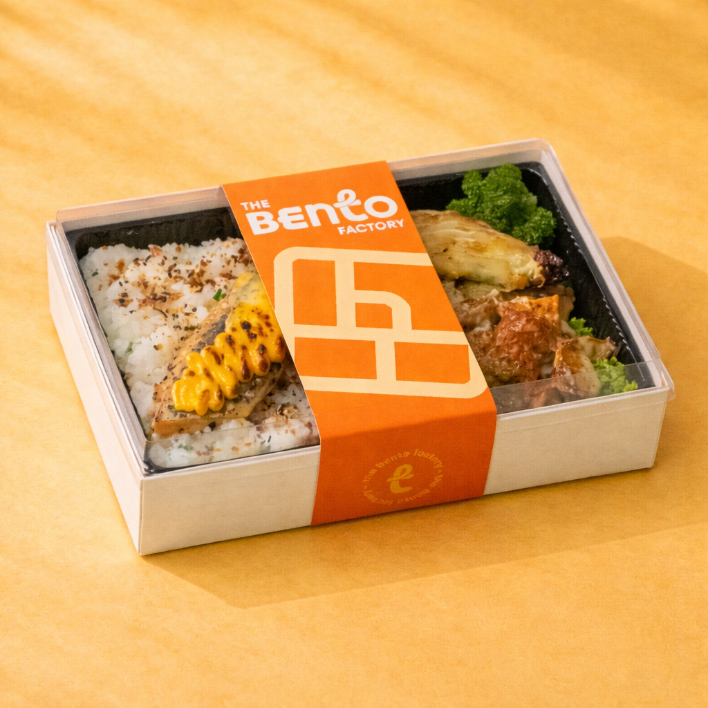 Mentaiko Salmon with Rice, potato salad, charred cabba with The Bento Factory Brand label over a rectangle bento box
